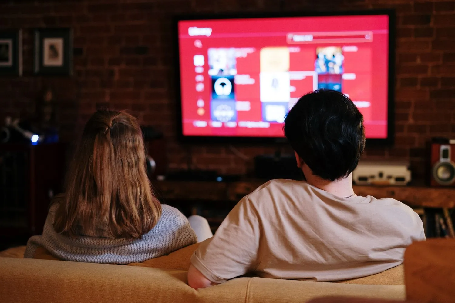 Couple watching streaming TV at home, the audience streaming TV and OTT ads reach that paid search misses